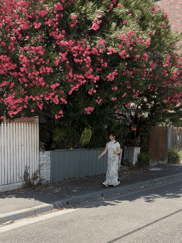 A picture of me with pink flowers in the back